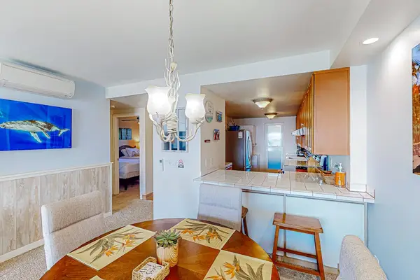 Dining room and bar stools at the counter of the kitchen for extra seating.