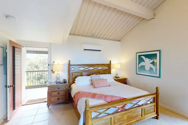 Rest peacefully in this airy bedroom with refreshing outdoor access