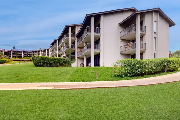 Charming property exterior surrounded by beautiful lawns and tropical scenery