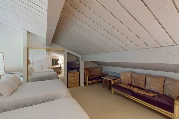 Bright loft bedroom provides extra sleeping space for relaxing nights
