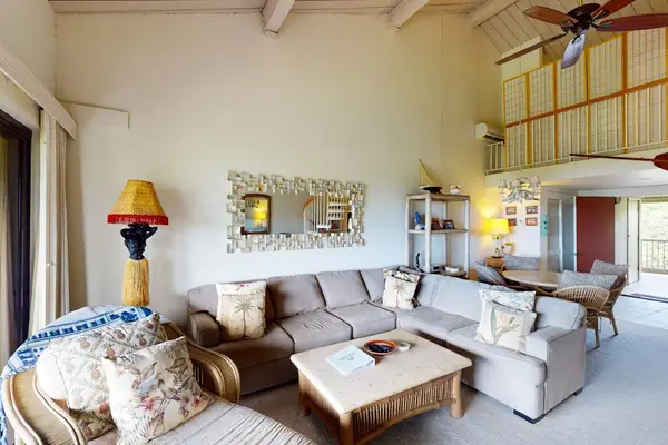 Spacious living area offers cozy seating beneath beautiful vaulted ceilings