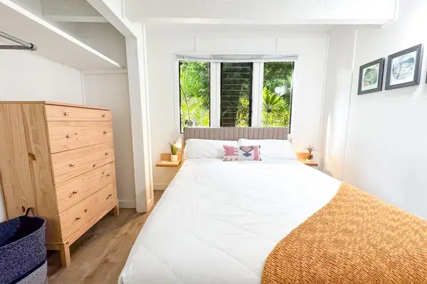 Second Bedroom includes warm quilt dresser storage and leafy window