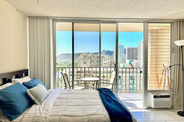 Bright studio interior with balcony and city views
