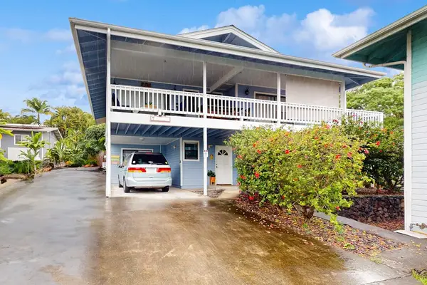 Beautiful multi-level property exterior featuring a private covered carport, lush landscaping, and a spacious upper balcony layout! 🏡✨