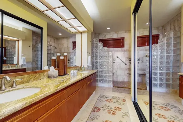 Spacious Primary En-Suite Bathroom with Dual Granite Vanity & Glass-Block Walk-In Shower