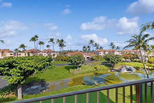 Elevated Balcony View Overlooking Resort Lawns, Palm Trees & Scenic Water Feature