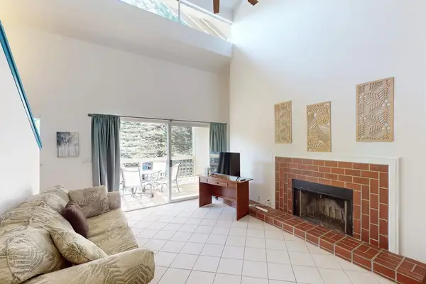 Living room with lots of natural light from your access to the private lanai and a flat screen tv.