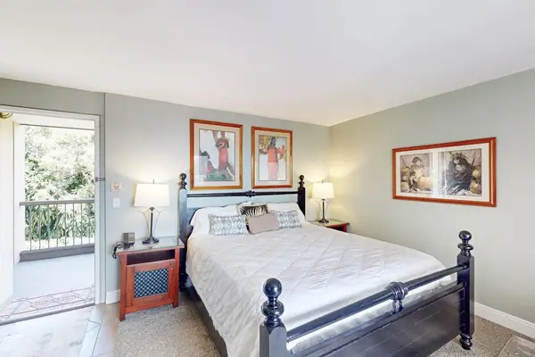 Four poster bed anchors a serene studio retreat with sunshine