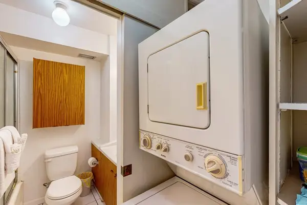 In-unit washer and dryer beside the full bathroom