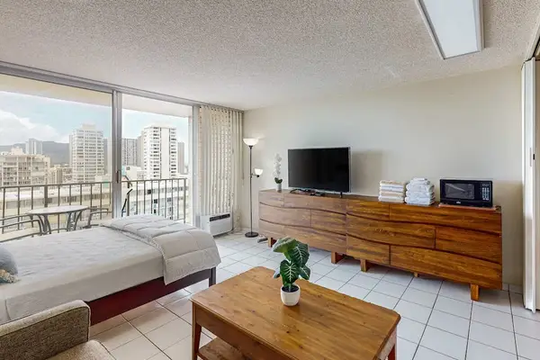 Studio living area with comfortable seating and city views