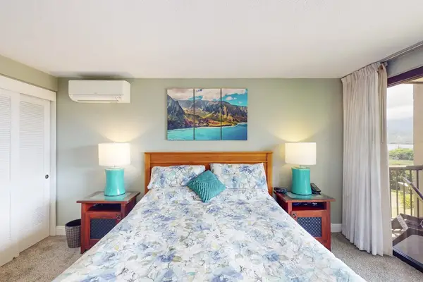 Showcases spacious layout beside balcony and soothing artwork