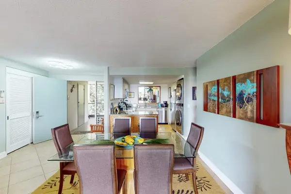Bright kitchen corridor showcases modern appliances colorful art and openness