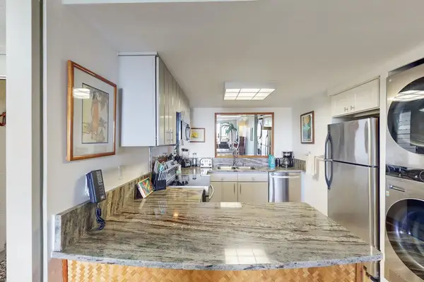Sleek galley kitchen pairs polished counters with streamlined everyday convenience