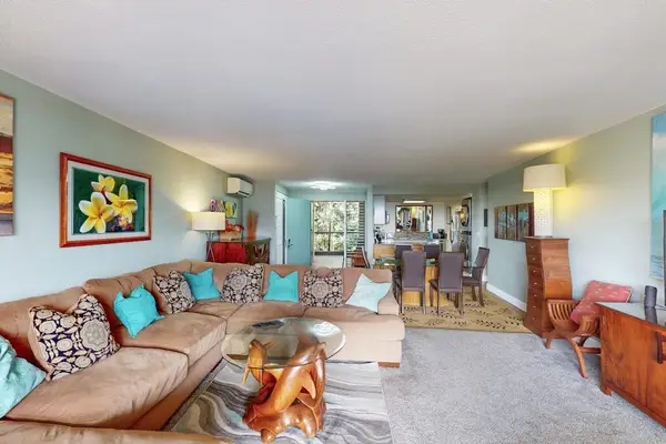 Colorful living room pairs cozy seating with cheerful island artwork