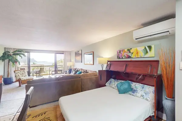 Rest comfortably in this peaceful bedroom with warm tropical touches
