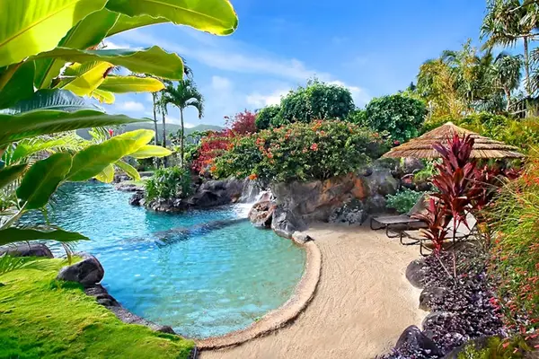 Sparkling pool offers calm waters, colorful gardens, and peaceful seating