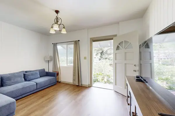 Relax in a bright and comfortable living room with a ceiling fan for added comfort.