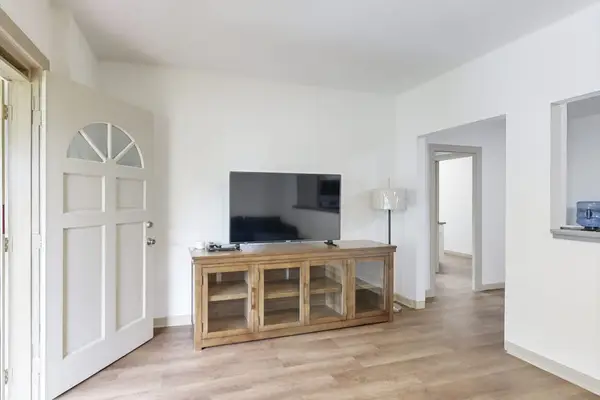 Relax and enjoy your favorite shows in a comfortable living room with a TV.