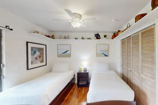 Bright Guest Bedroom Featuring Two Twin Beds & Nightstand
