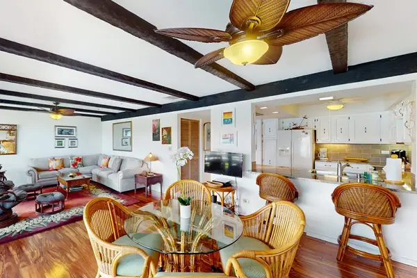 Spacious Open Living Area with Wicker Dining Set & Breakfast Bar