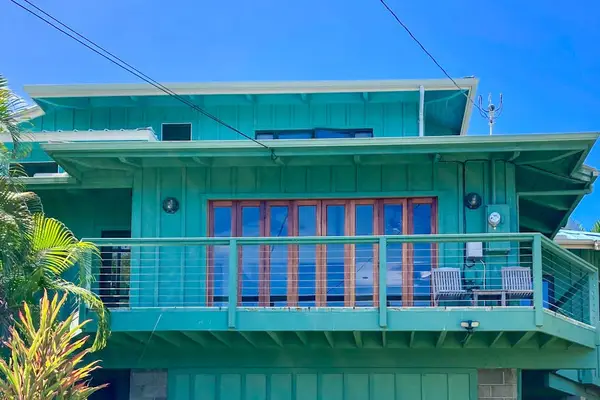 Modern architectural design. The home's striking teal facade stands beautifully against a clear blue sky, highlighting the clean structural lines and expansive upper deck. 📐🏡