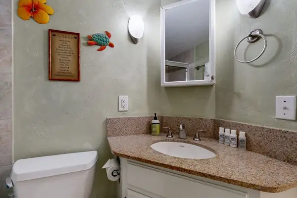 Single vanity bathroom with small mirror