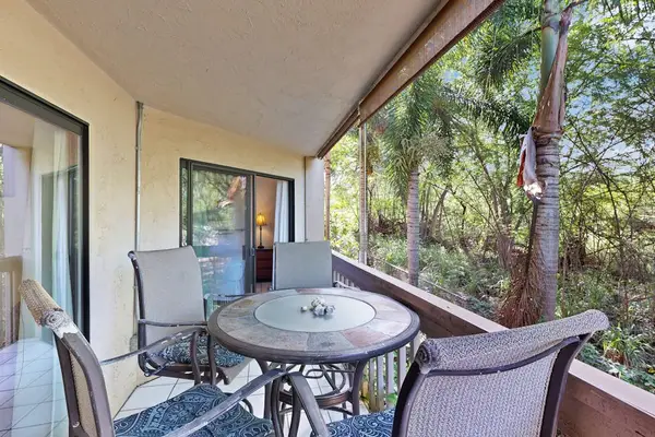 Private balcony with dinning table overlooking the lush greenery