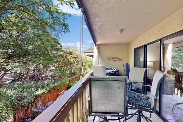 Private balcony with dinning table overlooking the lush greenery
