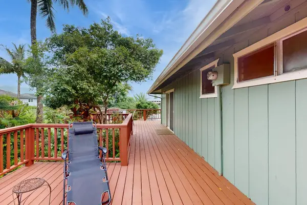 Step outside to the wraparound lanai, where lush tropical foliage creates a peaceful backdrop for morning coffee or evening conversation.