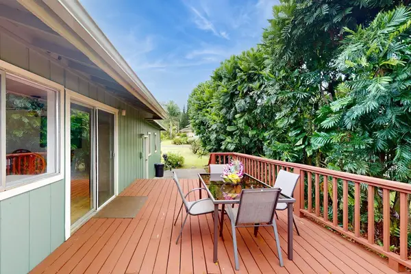 Step outside to the wraparound lanai, where lush tropical foliage creates a peaceful backdrop for morning coffee or evening conversation.