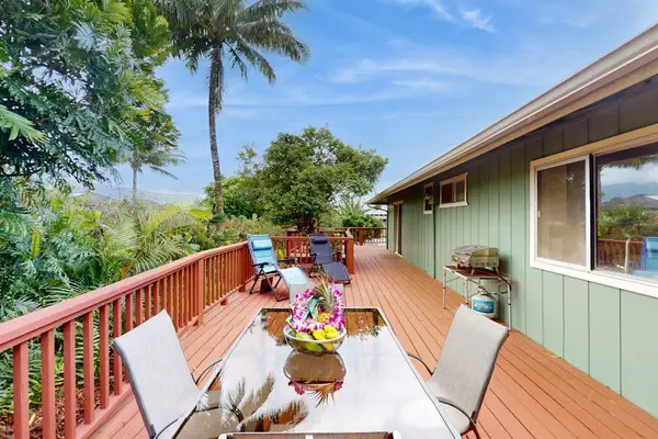 Step outside to the wraparound lanai, where lush tropical foliage creates a peaceful backdrop for morning coffee or evening conversation.