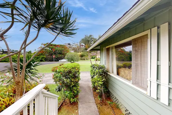 Lush tropical foliage surrounds this lovely home.