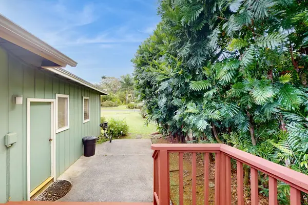 Step outside to the wraparound lanai, where lush tropical foliage creates a peaceful backdrop for morning coffee or evening conversation.