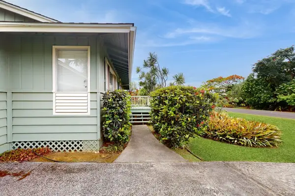 Lush tropical foliage surrounds this lovely home.