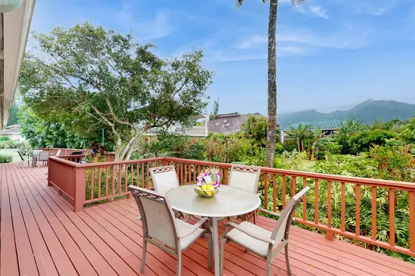 Step outside to the wraparound lanai, where lush tropical foliage creates a peaceful backdrop for morning coffee or evening conversation.