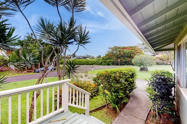 Lush tropical foliage surrounds this lovely home.
