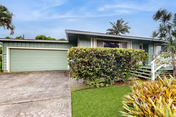 Lush tropical foliage surrounds this lovely home.
