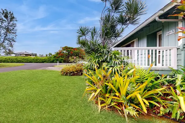 Lush tropical foliage surrounds this lovely home.
