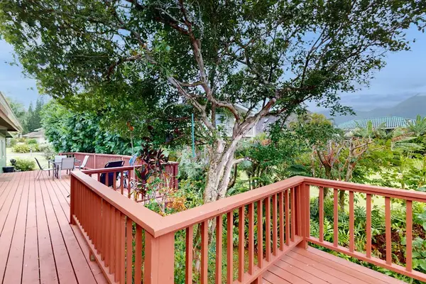 Step outside to the wraparound lanai, where lush tropical foliage creates a peaceful backdrop for morning coffee or evening conversation.