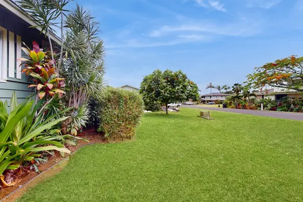 Lush tropical foliage surrounds this lovely home.