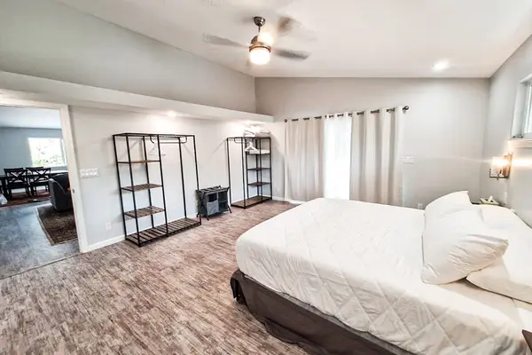 Large master bedroom with king bed and sliders to access the outside.