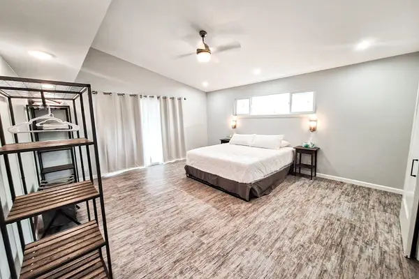 Large master bedroom with king bed and sliders to access the outside.