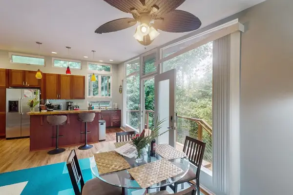 Bright dining area with lush forest views