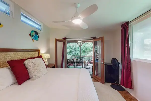 Wake up to peaceful tropical views from the bedroom