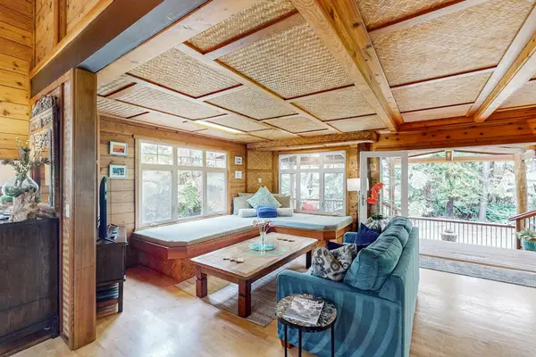 Bright open living space with scenic forest views