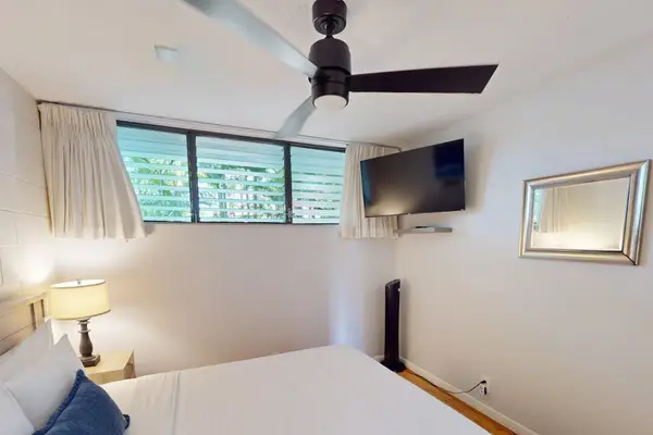 Guest Bedroom Suite Featuring Wall-Mounted Flat-Screen TV