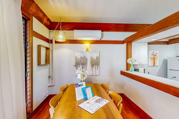 Dining room with a table and seating for four.