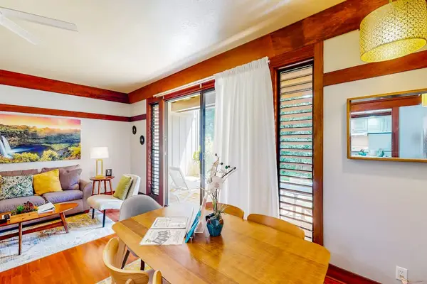 Dining room with a table and seating for four.