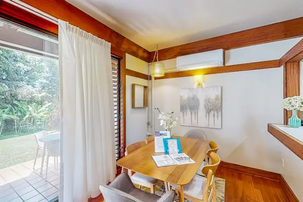 Dining room with a table and seating for four.