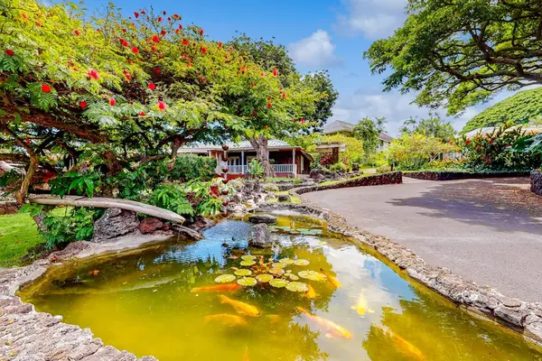 Kiahuna Plantation is a lush tropical oasis with vibrant gardens, swaying palms, and a tranquil koi pond, creating a peaceful island retreat just moments from the beach.